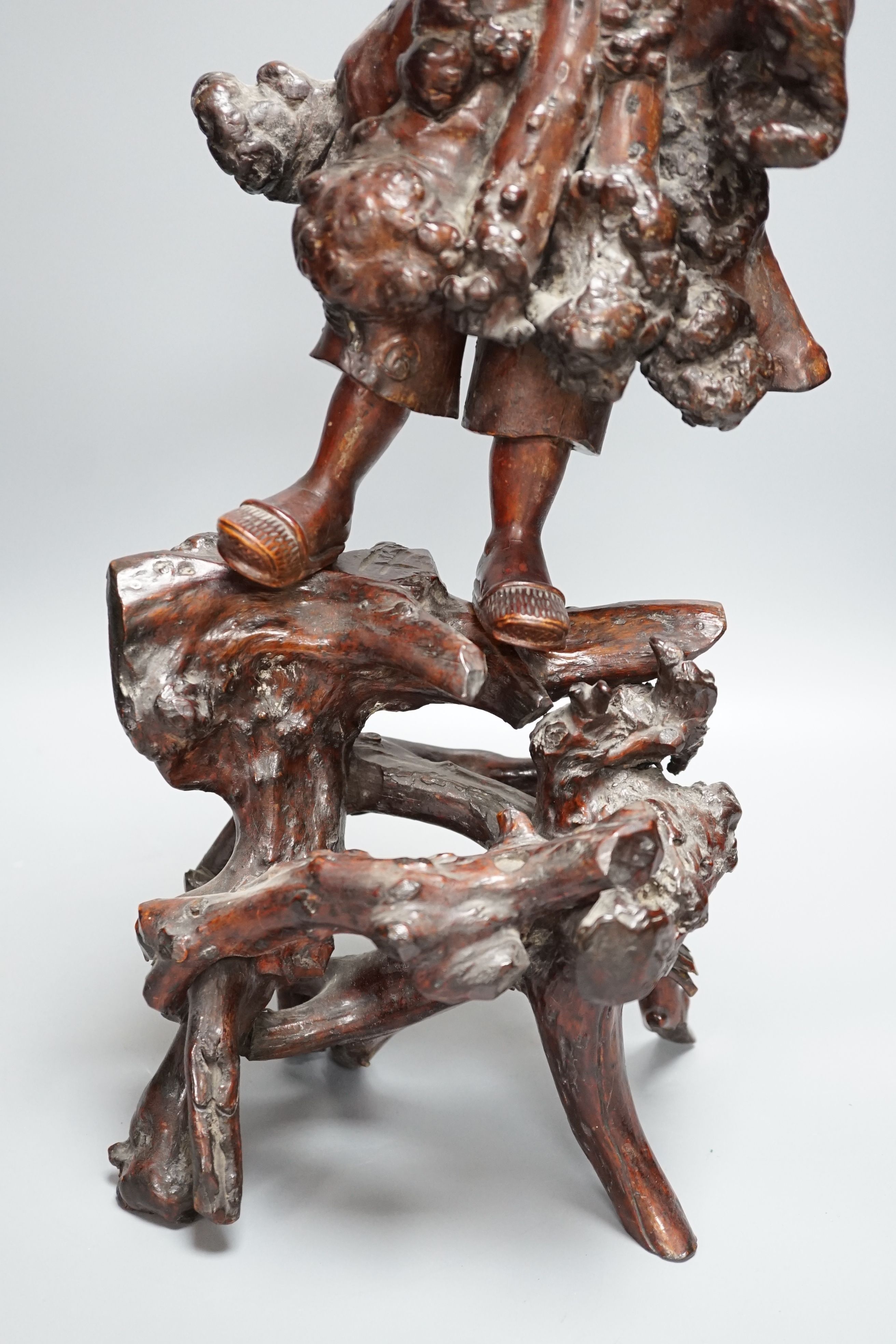 A Chinese root carving of a lady, 57cm